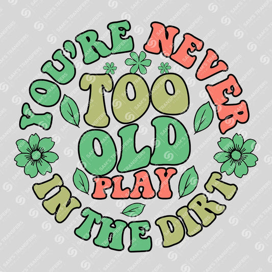 Apparel featuring a You're Never Too Old To Play In The Dirt-themed DTF transfer.