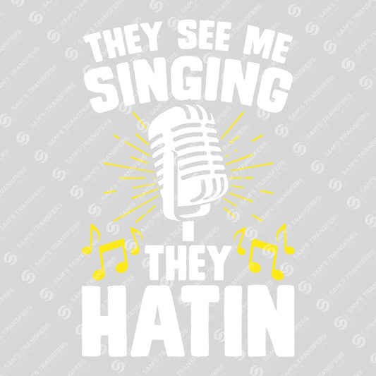 Apparel featuring a They See Me Singing They Hatin-themed DTF transfer.