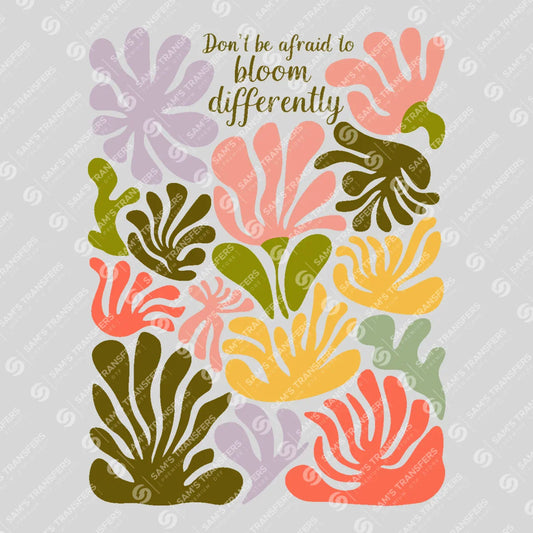 Apparel featuring a Don't Be Afraid To Bloom Differently-themed DTF transfer.