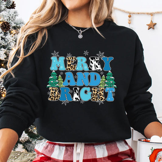 Black sweatshirt with colorful “Merry and Bright” DTF transfer design featuring leopard and cow prints, blue lettering, snowflakes, and Christmas trees, ideal for festive holiday apparel.