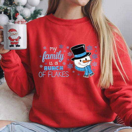 Red sweatshirt with “My Family Is a Bunch of Flakes” DTF transfer featuring a cute snowman in a blue scarf and top hat surrounded by snowflakes—perfect for funny holiday apparel.