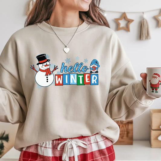 Beige sweatshirt with “Hello Winter” DTF transfer featuring a smiling snowman, blue-hat gnome, and colorful winter lettering—perfect for festive cold-weather apparel.