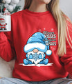 Red sweatshirt with “Winter Kisses Snowflake Wishes” DTF transfer featuring a cute gnome in a blue hat holding a snowflake, surrounded by snowflakes—perfect for winter apparel.