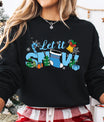 Black sweatshirt with “Let It Snow” DTF transfer featuring a blue stocking, candy cane, gifts, bell, and snowflakes—perfect for festive winter apparel.
