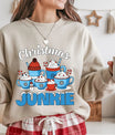 Beige sweatshirt with “Christmas Junkie” DTF transfer featuring holiday mugs with cocoa, whipped cream, and candy canes—perfect for cozy festive apparel.