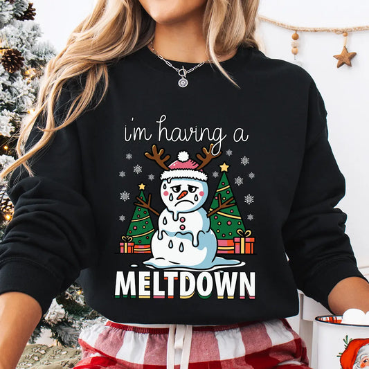 Black sweatshirt with “I’m Having a Meltdown” DTF transfer featuring a melting snowman with reindeer antlers, Christmas trees, and gifts—perfect for funny holiday apparel.