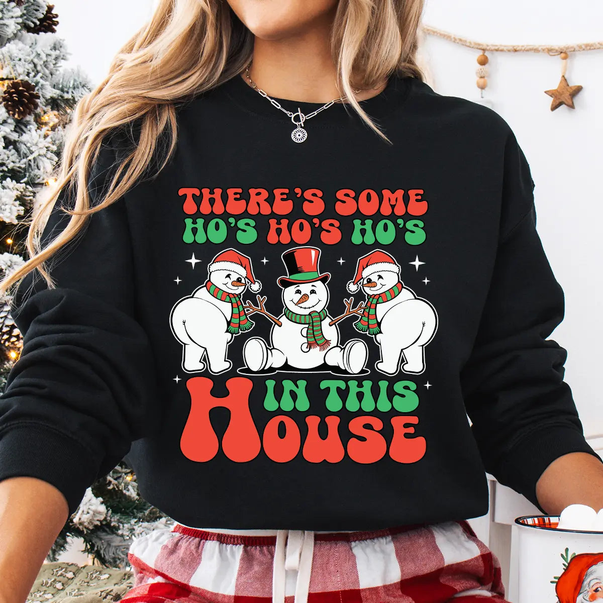 Black sweatshirt with “There’s Some Ho’s in This House” DTF transfer featuring three funny snowmen in Santa hats and scarves—perfect for humorous holiday apparel.