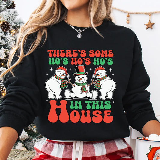 Black sweatshirt with “There’s Some Ho’s in This House” DTF transfer featuring three funny snowmen in Santa hats and scarves—perfect for humorous holiday apparel.