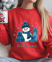 Red sweatshirt with “Winter Basics” DTF transfer featuring a smiling snowman, blue hat, boots, thermos, and snowflakes—perfect for cozy winter apparel.