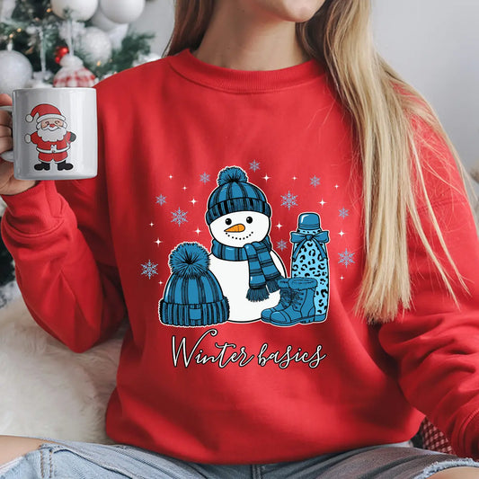Red sweatshirt with “Winter Basics” DTF transfer featuring a smiling snowman, blue hat, boots, thermos, and snowflakes—perfect for cozy winter apparel.