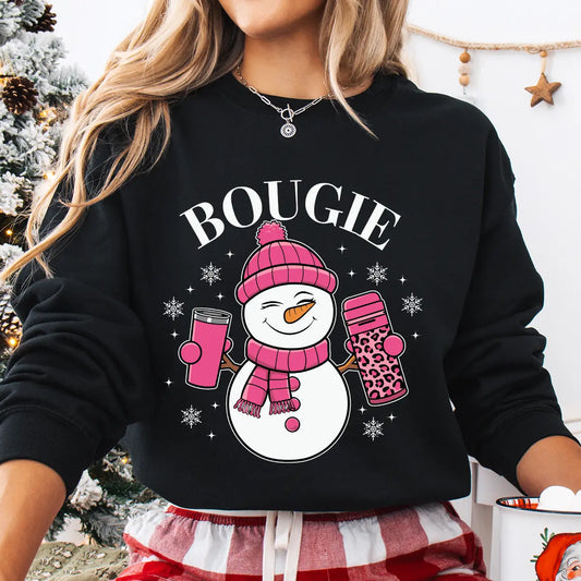 Black sweatshirt with “Bougie” DTF transfer featuring a smiling snowman in a pink hat and scarf holding coffee cups, surrounded by snowflakes—perfect for chic winter apparel.