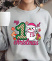 Gray sweatshirt with “My 1st Christmas” DTF transfer featuring a cute snowman in pink hat and scarf, candy, and presents.