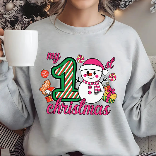 Gray sweatshirt with “My 1st Christmas” DTF transfer featuring a cute snowman in pink hat and scarf, candy, and presents.