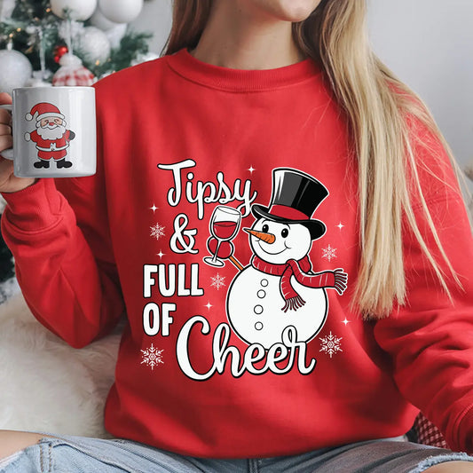 Red sweatshirt with “Tipsy & Full of Cheer” DTF transfer featuring a smiling snowman holding a wine glass and wearing a red scarf and top hat.