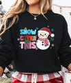 Black sweatshirt with “Snow One Cuter Than This” DTF transfer featuring a smiling snowman in a Santa hat and red scarf surrounded by colorful letters.