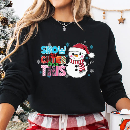 Black sweatshirt with “Snow One Cuter Than This” DTF transfer featuring a smiling snowman in a Santa hat and red scarf surrounded by colorful letters.