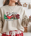 Beige sweatshirt with “For the Love of Christmas” design featuring a snowman in a red mug with candy cane, plaid letters, and festive holly decorations.