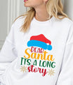 White sweatshirt with colorful text “Dear Santa, It’s a Long Story” and Santa hat graphic, perfect funny Christmas sweatshirt.