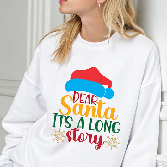 White sweatshirt with colorful text “Dear Santa, It’s a Long Story” and Santa hat graphic, perfect funny Christmas sweatshirt.