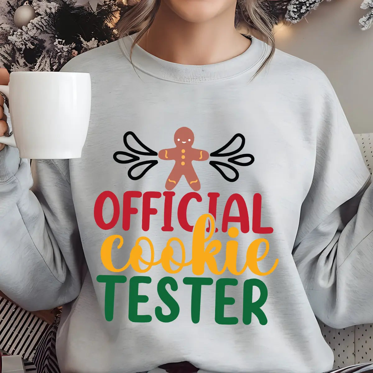 Grey sweatshirt with “Official Cookie Tester” text and gingerbread man design in festive red, gold, and green colors – fun Christmas baking sweatshirt.
