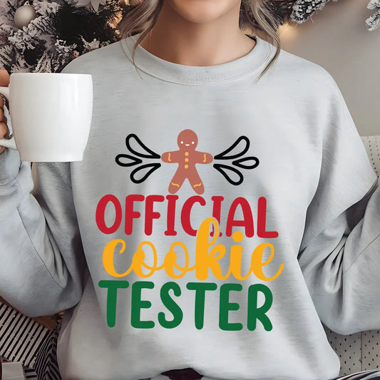 Grey sweatshirt with “Official Cookie Tester” text and gingerbread man design in festive red, gold, and green colors – fun Christmas baking sweatshirt.