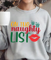 Grey sweatshirt with “On the Naughty List” design featuring red lips and green gifts – playful and fun Christmas sweatshirt.