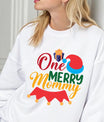 White sweatshirt with “One Merry Mommy” design featuring a Santa hat and gift, perfect festive apparel for moms at Christmas.