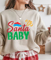 Beige sweatshirt with “Santa Baby” text in festive red and green colors with a Santa hat graphic, cozy Christmas apparel.