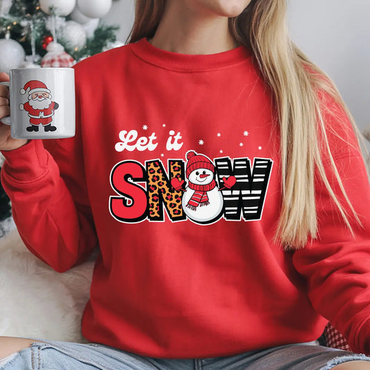 Red sweatshirt with “Let It Snow” design featuring leopard and striped letters with a cute snowman in the middle.