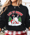 Black sweatshirt with funny upside-down snowman design and red “Let It Snow” text, surrounded by Christmas trees.