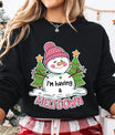 Black sweatshirt featuring a cute melting snowman in a pink hat with “I’m Having a Meltdown” text, surrounded by Christmas trees.