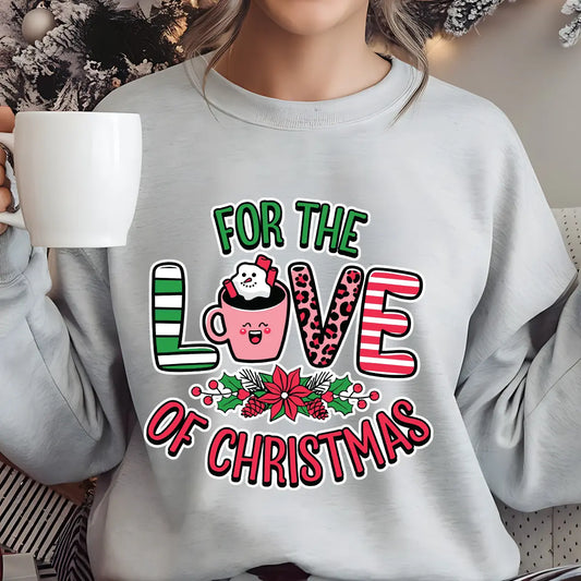 Gray sweatshirt featuring a pink hot cocoa mug with marshmallows and candy cane, surrounded by holly and the text “For the Love of Christmas” in festive red and green.