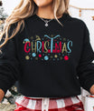 Black sweatshirt featuring colorful “Christmas” DTF design with reindeer, ornaments, snowflakes, and gifts—bright and festive holiday lettering style.