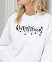 White sweatshirt featuring a black “Christmas” DTF design with ornaments, reindeer antlers, Santa hat, and snowflakes—minimal and elegant holiday style.
