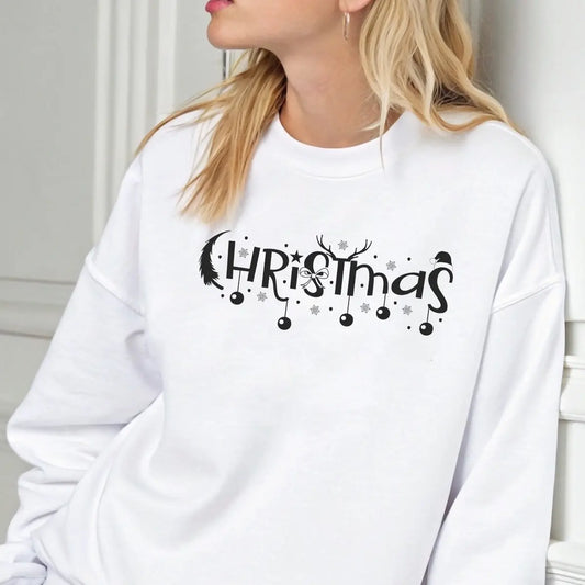White sweatshirt featuring a black “Christmas” DTF design with ornaments, reindeer antlers, Santa hat, and snowflakes—minimal and elegant holiday style.