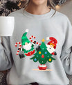 Gray sweatshirt with colorful DTF design featuring two Santas holding candy canes beside a decorated Christmas tree, festive holiday print.