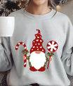 Gray sweatshirt with colorful DTF design of a Christmas gnome holding a candy cane and peppermint lollipop, festive holiday graphic.