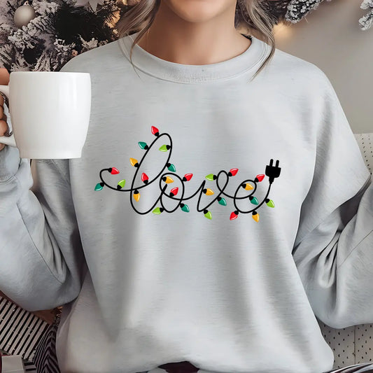 Gray sweatshirt with “love” written in Christmas light string design featuring multicolor bulbs.