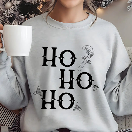 Gray sweatshirt with “Ho Ho Ho” Gothic-style DTF design featuring black letters, holly leaves, candy cane, and skull accents.