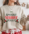 Beige Christmas sweatshirt with red and green “Spooky Merry Jolly” DTF design featuring skull and holly accents.