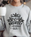 Gray Christmas sweatshirt with “Family Is the Greatest Christmas Gift” DTF design in festive typography and holly leaf details.