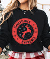 Black sweatshirt featuring red “North Pole Express” DTF design with leaping reindeer and snowflakes in a circular emblem.