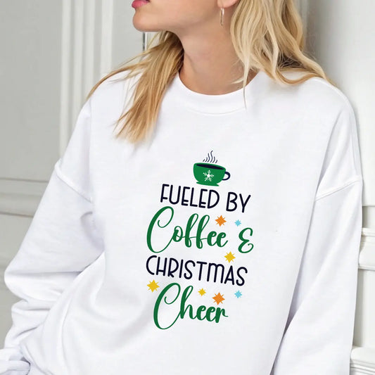 White sweatshirt with colorful “Fueled by Coffee & Christmas Cheer” design featuring a green coffee cup and festive stars.