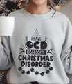 Gray sweatshirt with playful “I Have OCD – Obsessive Christmas Disorder” design featuring reindeer, Christmas tree, and ornaments.