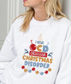 White sweatshirt featuring colorful “I Have OCD – Obsessive Christmas Disorder” design with reindeer, ornaments, and Christmas tree.