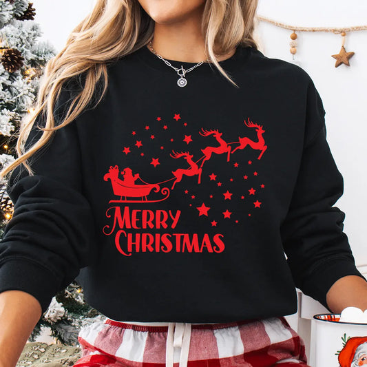 Black sweatshirt with red “Merry Christmas” DTF transfer showing Santa in a sleigh led by reindeer surrounded by stars.