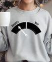 Gray sweatshirt with a playful black and white “Naughty or Nice” meter DTF transfer design featuring an arrow pointing toward “Naughty.”