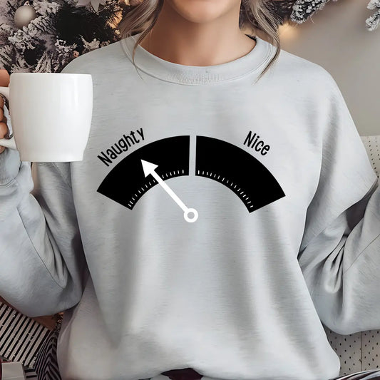 Gray sweatshirt with a playful black and white “Naughty or Nice” meter DTF transfer design featuring an arrow pointing toward “Naughty.”