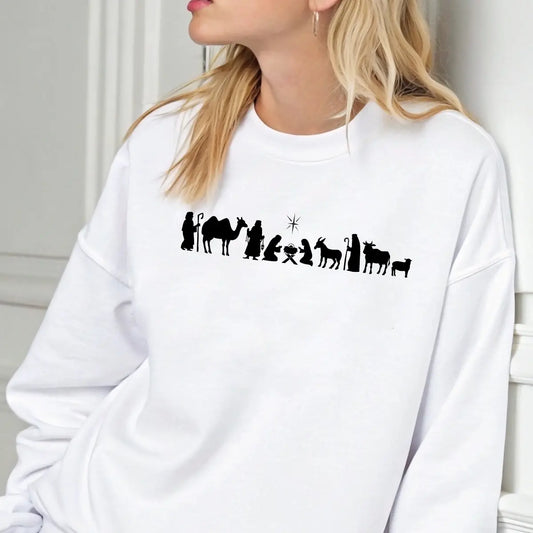 White sweatshirt with minimalist black nativity scene silhouette DTF transfer showing Mary, Joseph, baby Jesus, shepherds, and animals.