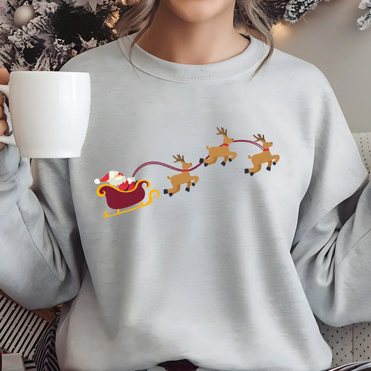 Grey sweatshirt with a colorful DTF transfer of Santa in a red sleigh pulled by three reindeer in flight.